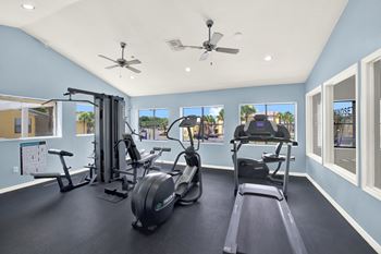 A spacious home gym with a variety of exercise equipment.